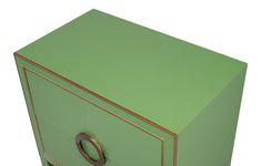 a green dresser with gold trim and handles