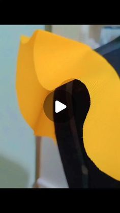 a close up of a yellow and black object with an arrow pointing to it's right