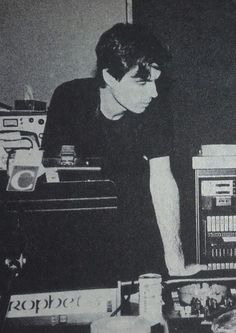 black and white photograph of a young man working on electronics