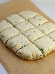 an uncooked cracker sitting on top of a piece of brown parchment paper