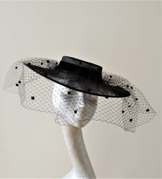 This is a stunning hat feature Spanish style boater in Black with a full merry widow veil . This style has been and still will be trending for the forth coming race season. Due to the shallow crown this does have a hat elastic to help securePlease note:- Handmade in the United Kingdom Buyers outside of the UK  may need to pay customs fees or duties, which vary from country to country. Also, customs can sometimes delay delivery by many days. We want buyers to know that any customs delays are not Curved Brim Fascinator For Royal Ascot, Merry Widow, Veiled Hats, Hair Nets, Boater Hat, Elegant Hats, Millinery Hats, Black Veil, Cloche Hat