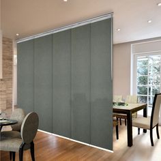 a dining room with sliding glass doors and chairs