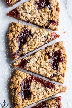 four pieces of fruit and oatmeal breakfast bar on a white table top