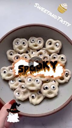 a bowl filled with halloween treats and googly eyes on top of the words trick written in front of them