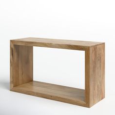 a wooden shelf sitting on top of a white wall