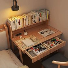 a wooden desk with books and magazines on it next to a chair in a room