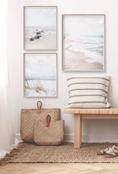 three framed pictures hang on the wall next to a bench with a bag and slippers