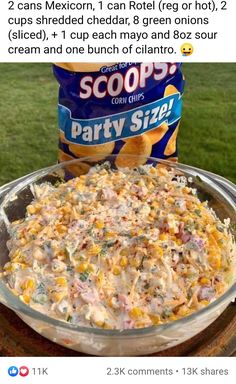 an image of a bowl of party size corn salad with chips on it and a bag of scoops in the background