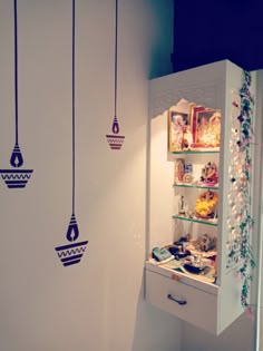 an open refrigerator with hanging decorations on the wall