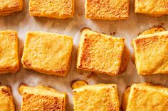 several square pieces of bread sitting on top of a table