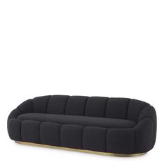 a black couch sitting on top of a white floor