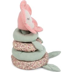 a stack of pillows with a pink bird on top