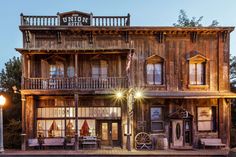 an old wooden building with lots of windows and balconies on the top floor