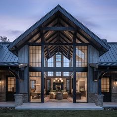 a large open floor plan with glass doors and windows on the front of the house