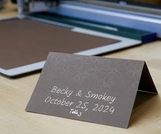 a wedding place card sitting on top of a table