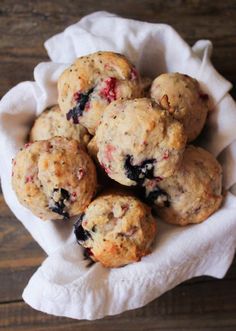 a bunch of muffins sitting on top of a white cloth