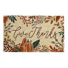 a door mat with the words give thanks written on it and pumpkins, leaves and acorns