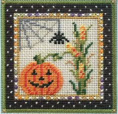 a cross stitch pattern with a pumpkin and flowers