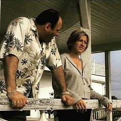 a man and woman are standing on the porch