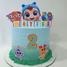 there is a birthday cake with the number two on it and characters in the background