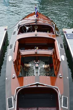 the inside of a wooden boat docked at a dock