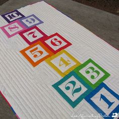 a quilted table runner with colorful numbers on it