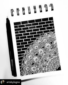 a black and white drawing of a brick wall with flowers on it, next to a marker