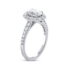 a white gold engagement ring with an oval diamond center