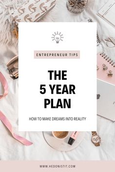 the 5 year plan is on top of a white table with pink ribbon and other items