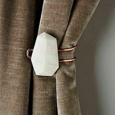 a close up of a curtain with a tie bar