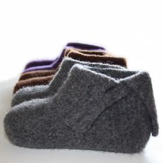 three pairs of wool socks sitting on top of a white table next to each other