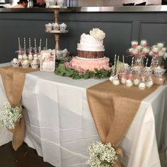 a table topped with lots of cake and cupcakes