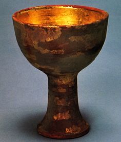 an old, rusty looking bowl on a blue background