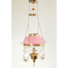 a pink and gold chandelier hanging from a ceiling