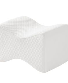 the side view of a white mattress with no sheets on it, in front of a white background