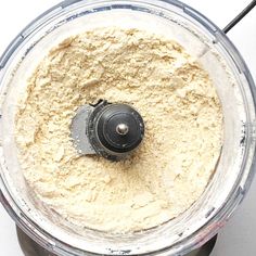 a food processor filled with flour on top of a table