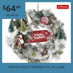 the north pole trading co village christmas wreath is $ 64 00 and it's on sale for $ 48 00