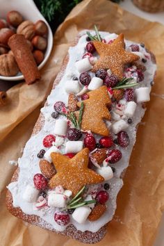 a christmas bread with cranberries, pineapples and other holiday foods on it