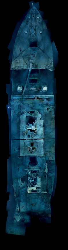 an old clock tower in the dark with blue paint on it's face and bottom part