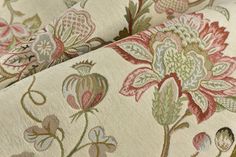 an upholstered fabric with flowers and leaves on it