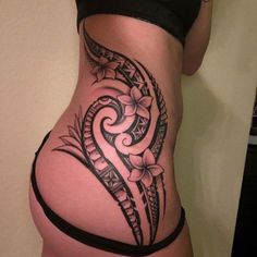 a woman's stomach with an intricate tattoo design on the side and bottom part