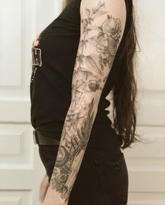 a woman's arm with flowers on it