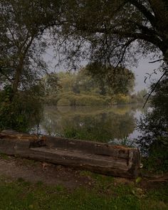 a wooden bench sitting next to a lake