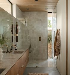 a bathroom with two sinks and a shower