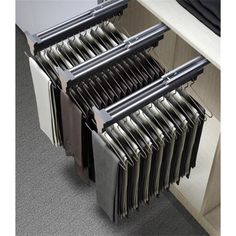 an open drawer with several files and folders in it on the side of a cabinet