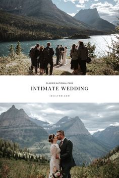 a couple kissing in front of some mountains and people standing on the grass near water