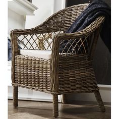 a wicker chair sitting in front of a fireplace