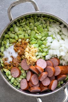 a large pot filled with lots of different types of vegetables and meats on top of it