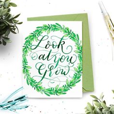 a card with the words look at you grow on it and surrounded by greenery