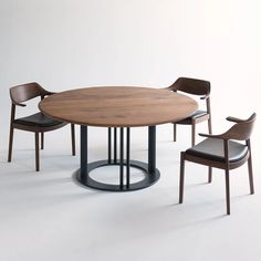 a round table with four chairs around it